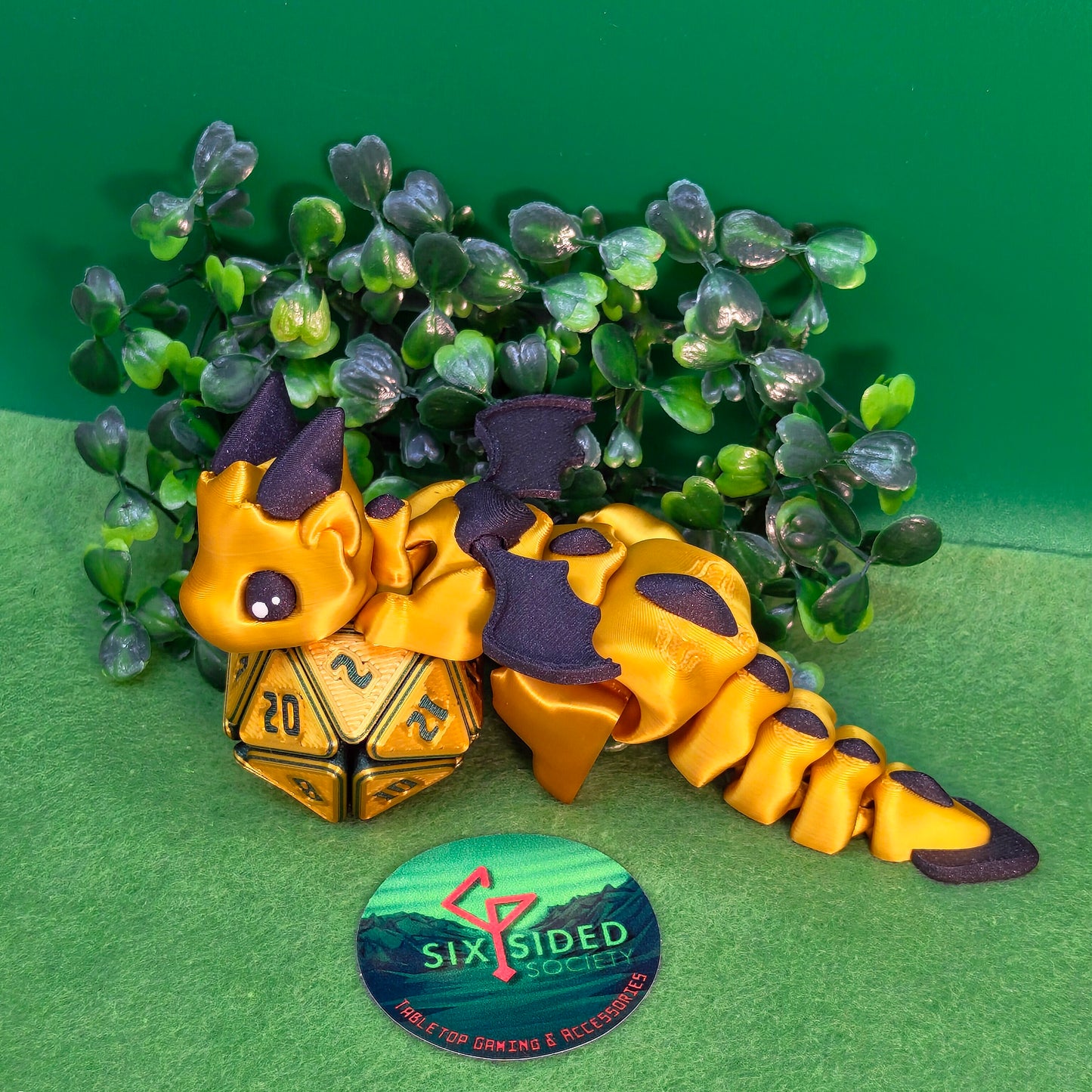 3D printed articulated baby dragon figurine for tabletop gaming – perfect Dungeons & Dragons gift, RPG accessory, and fantasy desk decor. Multi‑colour PLA dragon with movable wings and tail for fidget play during D&D, Pathfinder, and TTRPG campaigns. Ideal gamer gift for Dungeon Masters, dice collectors, and fantasy enthusiasts – handcrafted by Six Sided Society in Coventry, UK.