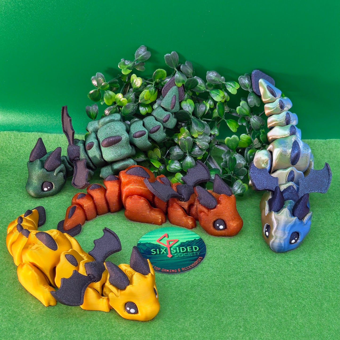 3D printed articulated baby dragon figurine for tabletop gaming – perfect Dungeons & Dragons gift, RPG accessory, and fantasy desk decor. Multi‑colour PLA dragon with movable wings and tail for fidget play during D&D, Pathfinder, and TTRPG campaigns. Ideal gamer gift for Dungeon Masters, dice collectors, and fantasy enthusiasts – handcrafted by Six Sided Society in Coventry, UK.