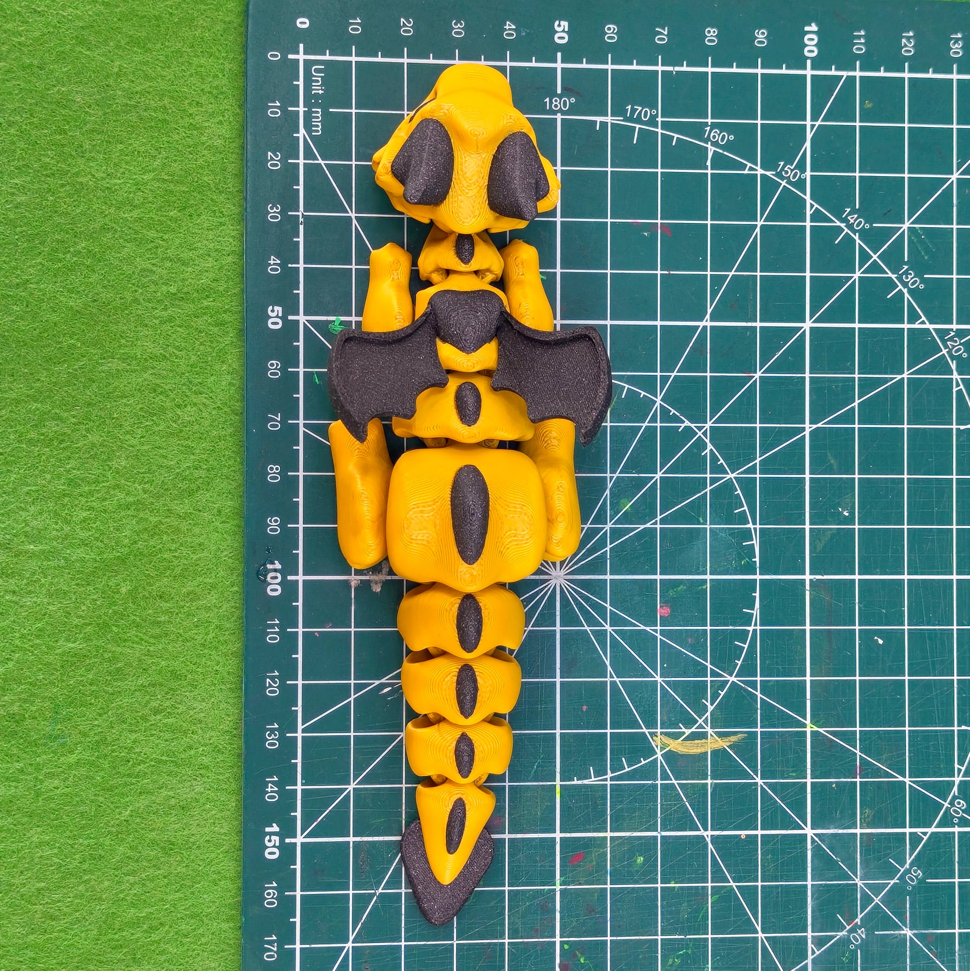 3D printed articulated baby dragon figurine for tabletop gaming – perfect Dungeons & Dragons gift, RPG accessory, and fantasy desk decor. Multi‑colour PLA dragon with movable wings and tail for fidget play during D&D, Pathfinder, and TTRPG campaigns. Ideal gamer gift for Dungeon Masters, dice collectors, and fantasy enthusiasts – handcrafted by Six Sided Society in Coventry, UK.